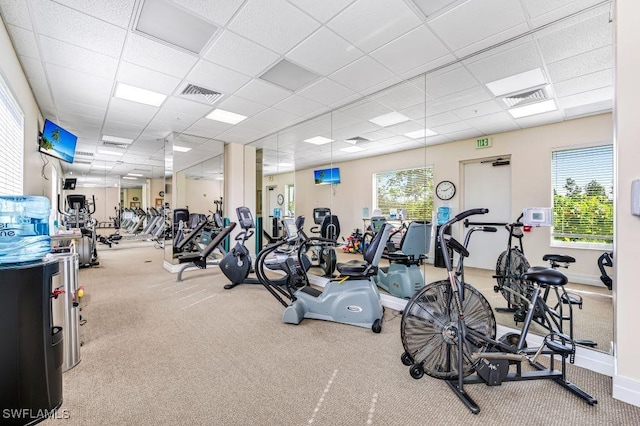 gym with carpet, a drop ceiling, and visible vents