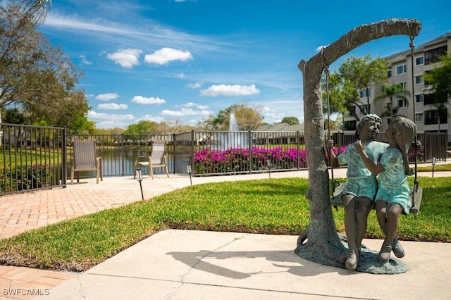 view of home's community featuring fence
