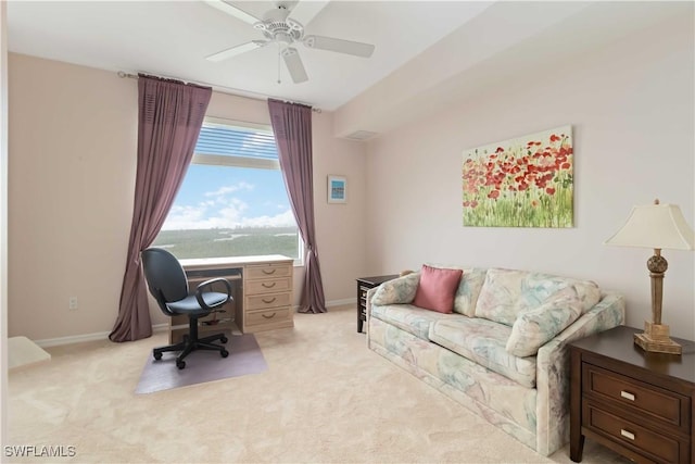 office area featuring baseboards, a ceiling fan, and light carpet