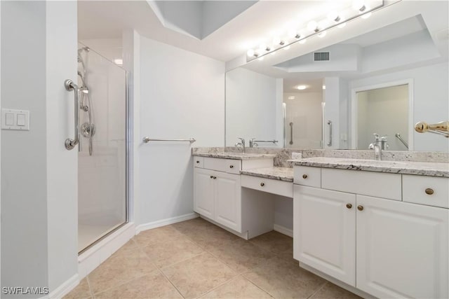 bathroom featuring a tray ceiling, a stall shower, a sink, and visible vents
