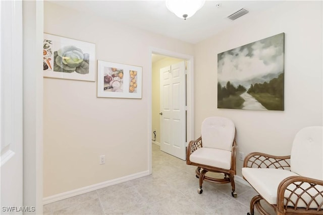 living area featuring visible vents, baseboards, and light tile patterned floors