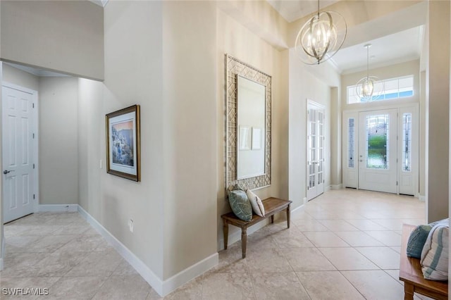 9282 Quarry Dr, Naples, FL 34120 - foyer with a towering ceiling, baseboards, and an inviting chandelier
