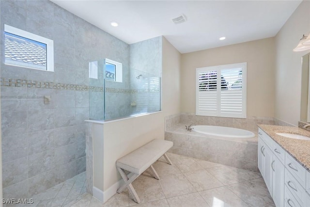9282 Quarry Dr, Naples, FL 34120 - bathroom featuring visible vents, a walk in shower, vanity, tile patterned floors, and a garden tub
