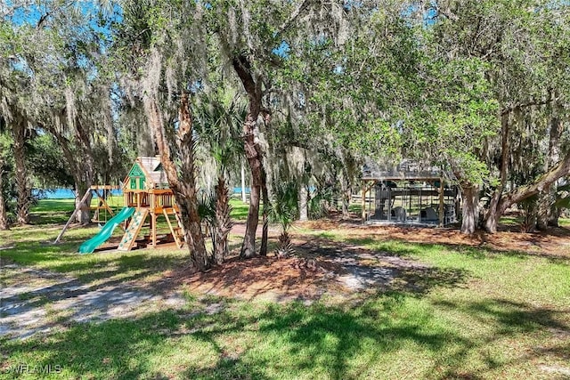 community jungle gym with a lawn
