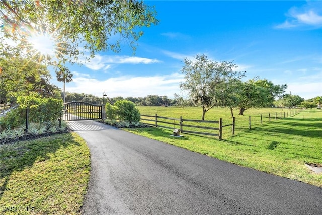 view of street with a gate and a rural view