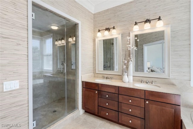 bathroom featuring tile patterned floors, a sink, and a stall shower