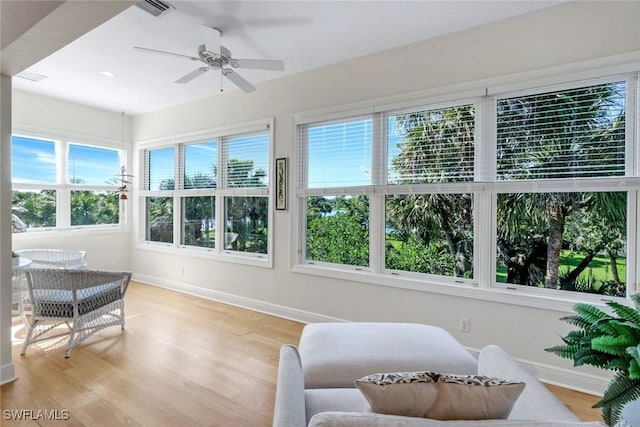 sunroom / solarium featuring baseboards, wood finished floors, visible vents, and recessed lighting