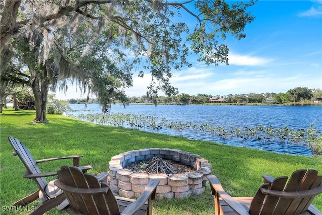 view of yard featuring a water view and an outdoor fire pit
