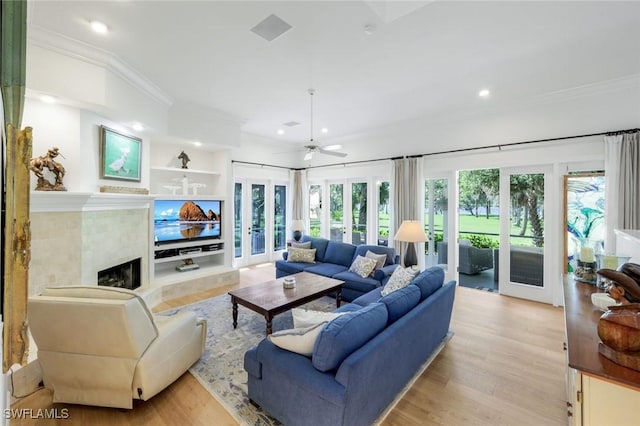 living room with a ceiling fan, light wood-style floors, french doors, ornamental molding, and recessed lighting