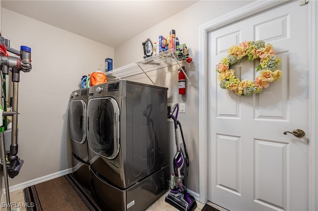 laundry area featuring separate washer and dryer, baseboards, and laundry area
