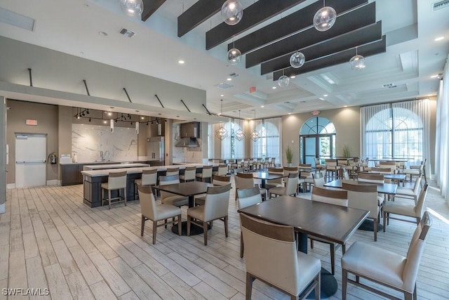 5467 Ferris Ave, Ave Maria, FL 34142 - dining space with light wood-style floors and beamed ceiling