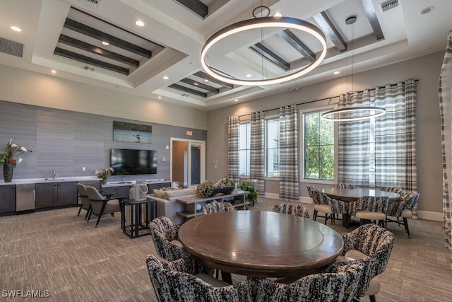 5467 Ferris Ave, Ave Maria, FL 34142 - dining room with coffered ceiling, light colored carpet, baseboards, beam ceiling, and a towering ceiling