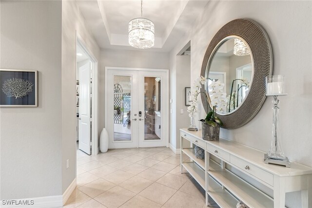 4194 Aspen Chase Dr, Naples, FL 34119 - foyer entrance with french doors, a chandelier, and light tile patterned flooring