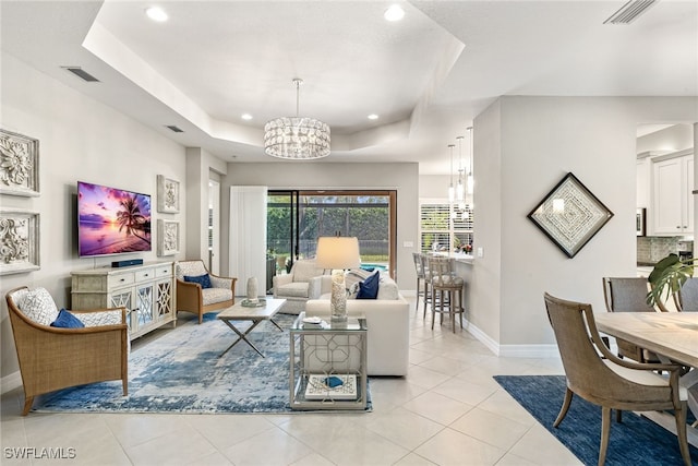 4194 Aspen Chase Dr, Naples, FL 34119 - living room with a chandelier, a tray ceiling, recessed lighting, and light tile patterned floors