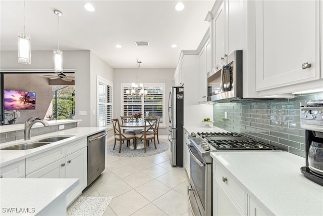 4194 Aspen Chase Dr, Naples, FL 34119 - kitchen featuring appliances with stainless steel finishes, light countertops, white cabinets, backsplash, and recessed lighting