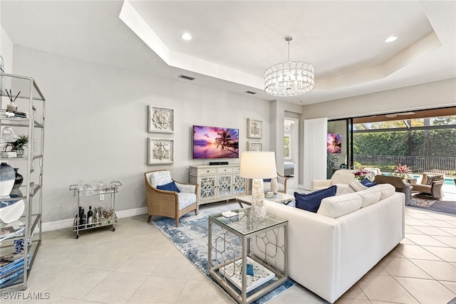 4194 Aspen Chase Dr, Naples, FL 34119 - living room with a tray ceiling, light tile patterned floors, a chandelier, and recessed lighting