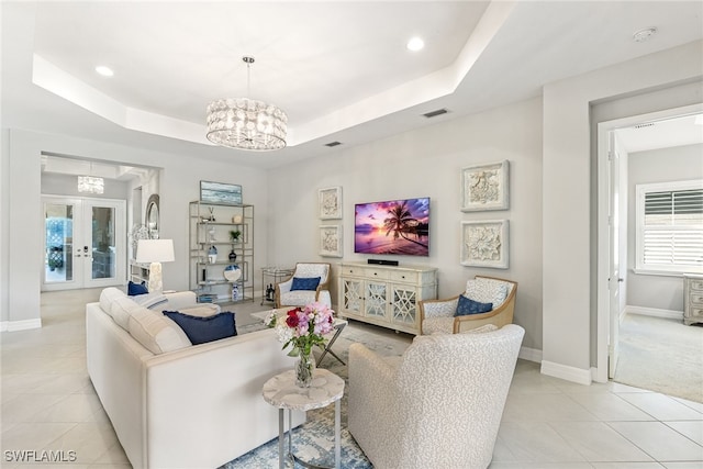 4194 Aspen Chase Dr, Naples, FL 34119 - living room featuring light tile patterned floors, a chandelier, a tray ceiling, french doors, and recessed lighting