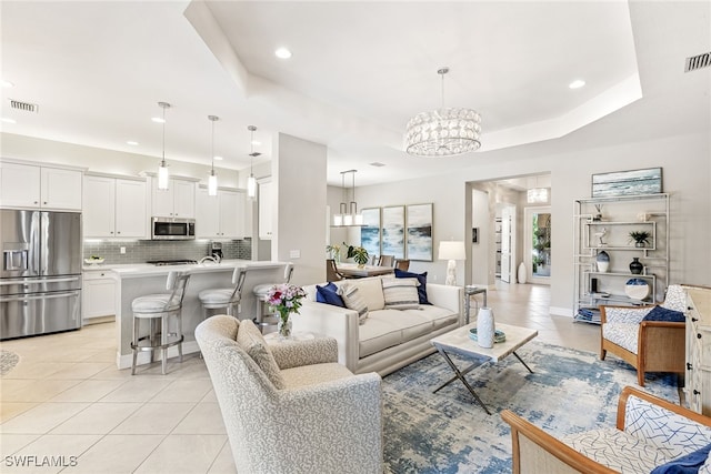 4194 Aspen Chase Dr, Naples, FL 34119 - living room featuring a chandelier, light tile patterned floors, recessed lighting, and a raised ceiling