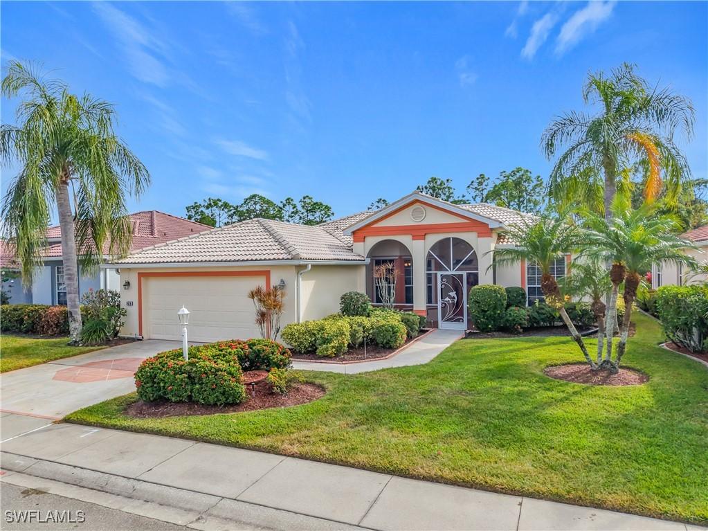 2070 Palo Duro Blvd, North Fort Myers, FL 33917 - mediterranean / spanish-style house with concrete driveway, stucco siding, an attached garage, a front yard, and a tiled roof