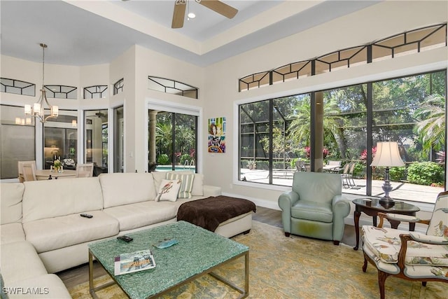 3370 Oaklake Ct, Bonita Springs, FL 34134 - living area featuring baseboards, recessed lighting, a high ceiling, ceiling fan with notable chandelier, and wood finished floors
