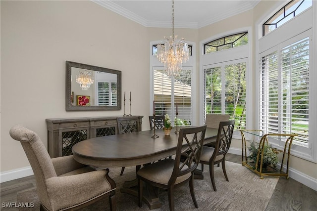 3370 Oaklake Ct, Bonita Springs, FL 34134 - dining space with crown molding, a towering ceiling, wood finished floors, a notable chandelier, and baseboards