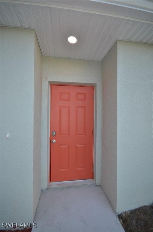 3341 Willard St, Fort Myers, FL 33916 - doorway to property featuring stucco siding