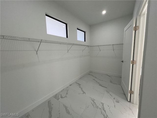 spacious closet with marble finish floor