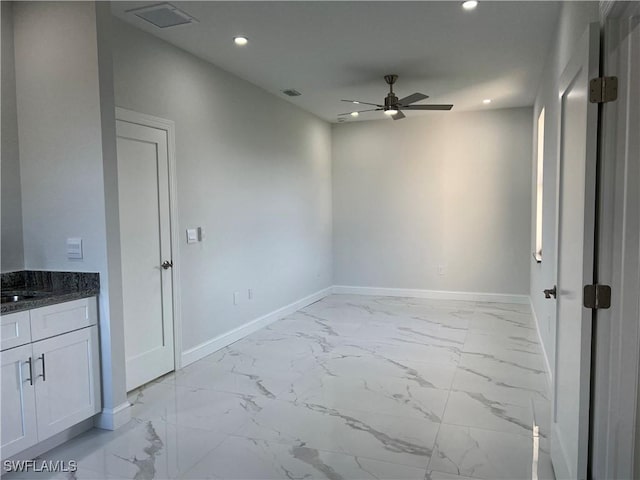 unfurnished room with recessed lighting, marble finish floor, baseboards, and ceiling fan
