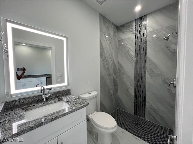 full bath featuring vanity, visible vents, marble finish floor, toilet, and a marble finish shower