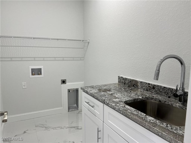 clothes washing area with marble finish floor, hookup for a washing machine, electric dryer hookup, a sink, and cabinet space