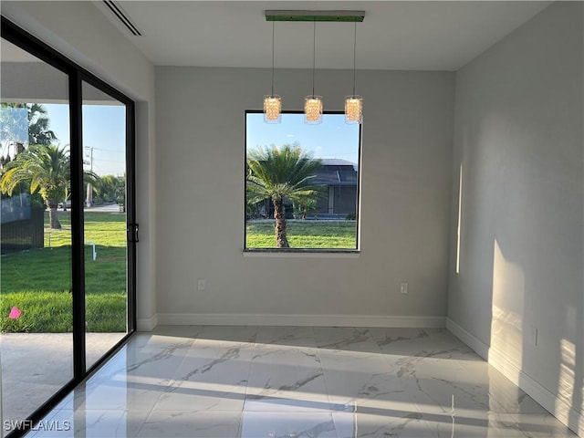 unfurnished room featuring baseboards and marble finish floor