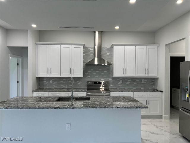 3014 6th St W, Lehigh Acres, FL 33971 - kitchen with stainless steel appliances, wall chimney exhaust hood, recessed lighting, tasteful backsplash, and light marble finish flooring