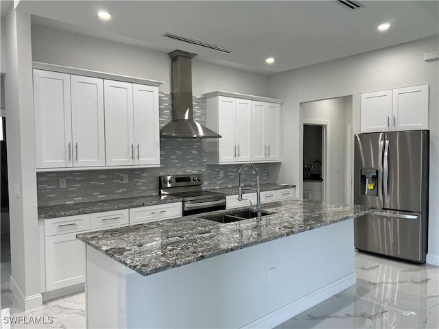 3014 6th St W, Lehigh Acres, FL 33971 - kitchen with appliances with stainless steel finishes, wall chimney range hood, light marble finish floors, recessed lighting, and decorative backsplash