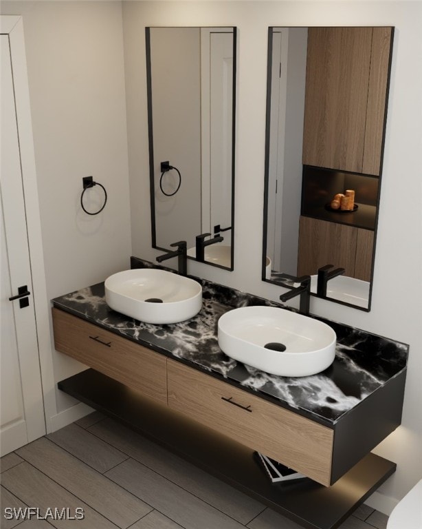 1118 Fontana St E, Lehigh Acres, FL 33974 - bathroom with double vanity and wood finished floors