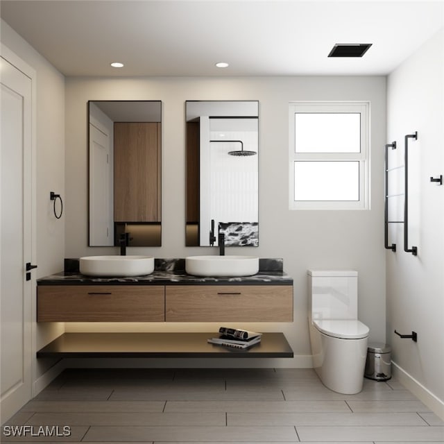 1118 Fontana St E, Lehigh Acres, FL 33974 - full bath featuring double vanity, toilet, baseboards, recessed lighting, and wood finished floors