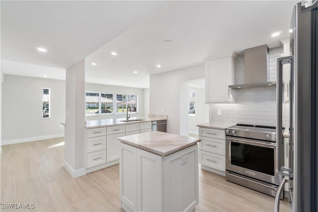 25900 Hickory Blvd Unit 101, Bonita Springs, FL 34134 - kitchen with light wood-style floors, wall chimney range hood, appliances with stainless steel finishes, and a sink
