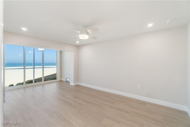 25900 Hickory Blvd Unit 101, Bonita Springs, FL 34134 - spare room with a ceiling fan, baseboards, and light wood-style floors