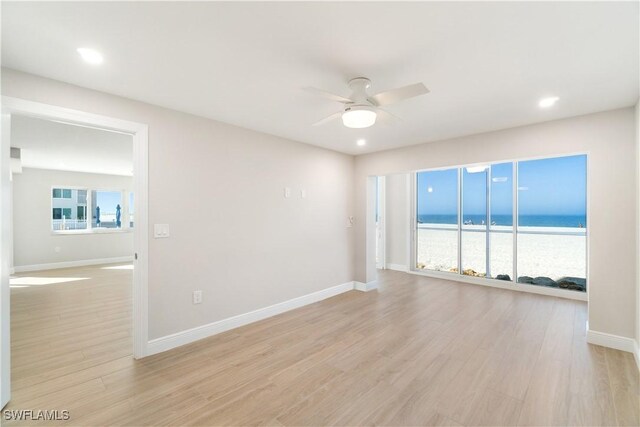 25900 Hickory Blvd Unit 101, Bonita Springs, FL 34134 - unfurnished room with light wood finished floors, a water view, baseboards, recessed lighting, and ceiling fan