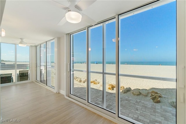25900 Hickory Blvd Unit 101, Bonita Springs, FL 34134 - unfurnished sunroom with wood finished floors, a water view, and floor to ceiling windows