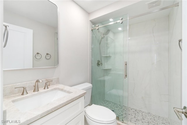 25900 Hickory Blvd Unit 101, Bonita Springs, FL 34134 - bathroom with visible vents, a marble finish shower, vanity, and toilet