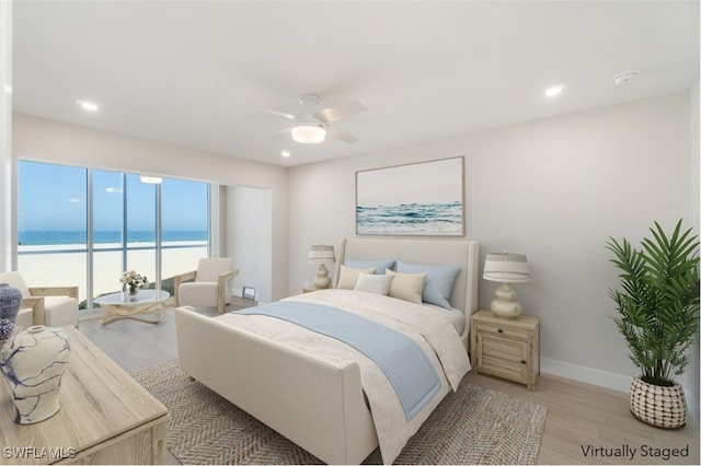 25900 Hickory Blvd Unit 101, Bonita Springs, FL 34134 - bedroom featuring recessed lighting, baseboards, light wood-style floors, and a water view