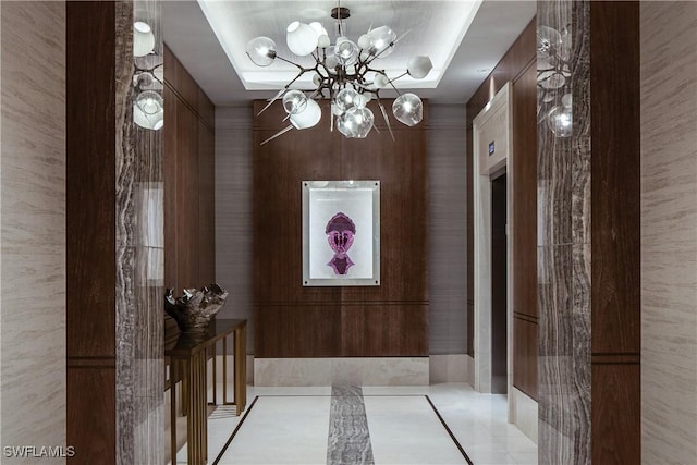 6897 Grenadier Blvd Unit 1602, Naples, FL 34108 - hallway with light tile patterned floors and an inviting chandelier