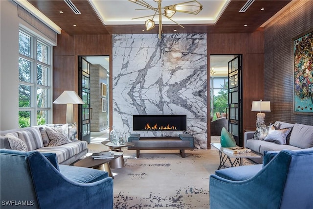 6897 Grenadier Blvd Unit 1602, Naples, FL 34108 - living room featuring a high ceiling, wood walls, and a high end fireplace