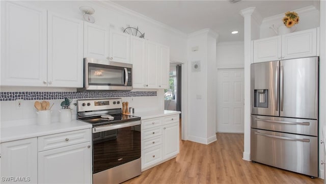 1824 SE 20th Ln, Cape Coral, FL 33990 - kitchen with stainless steel appliances, decorative backsplash, and white cabinets