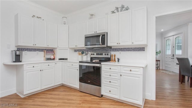 1824 SE 20th Ln, Cape Coral, FL 33990 - kitchen featuring crown molding, light countertops, stainless steel appliances, and white cabinetry