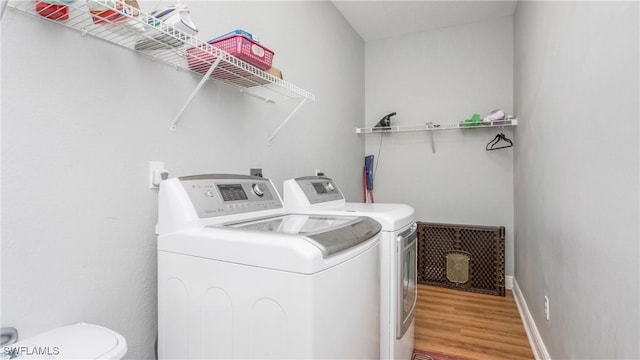 1824 SE 20th Ln, Cape Coral, FL 33990 - laundry area featuring separate washer and dryer, laundry area, and wood finished floors