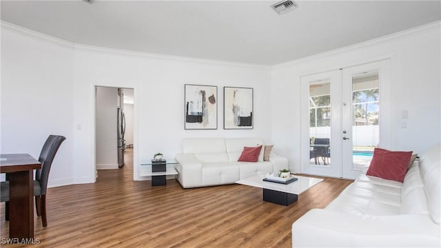 1824 SE 20th Ln, Cape Coral, FL 33990 - living room with crown molding, light wood-style flooring, french doors, and visible vents