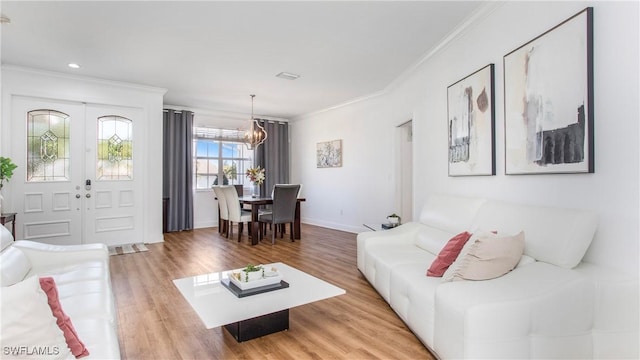 1824 SE 20th Ln, Cape Coral, FL 33990 - living area with french doors, crown molding, an inviting chandelier, baseboards, and light wood-style floors