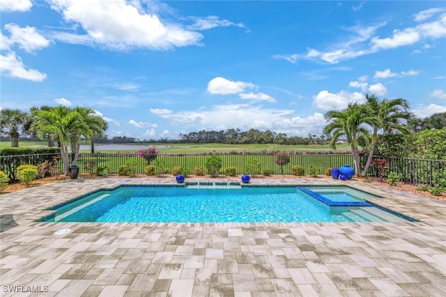 view of pool with fence, a patio area, and a pool with connected hot tub