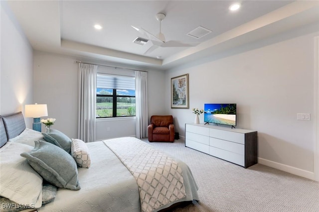 carpeted bedroom with baseboards, visible vents, recessed lighting, and a tray ceiling